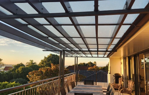Architectural pergola with lightweight transparent NexaGlaze panels covering a residential outdoor deck.